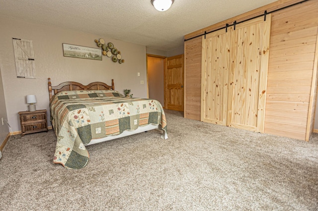17366 Ryan Dr NE, Osakis, MN 56360 - bedroom with a barn door, carpet flooring, and a textured ceiling