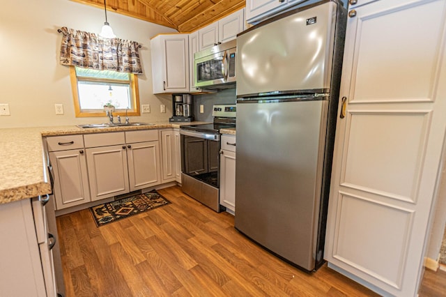17366 Ryan Dr NE, Osakis, MN 56360 - kitchen with appliances with stainless steel finishes, wooden ceiling, a sink, wood finished floors, and decorative light fixtures
