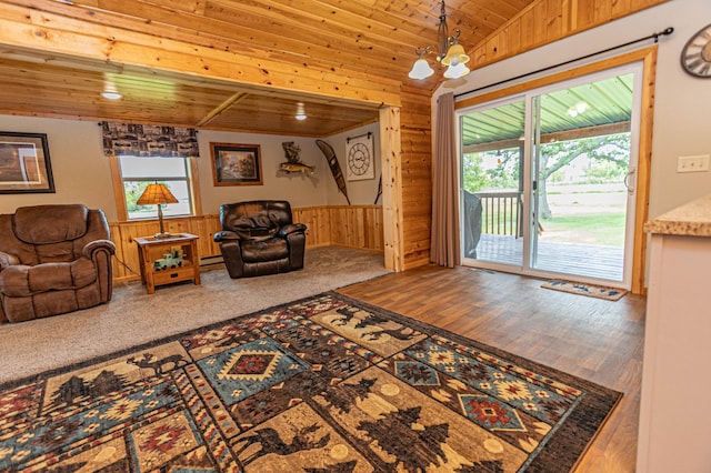 17366 Ryan Dr NE, Osakis, MN 56360 - living room featuring wood ceiling, wood walls, a wainscoted wall, a chandelier, and a baseboard radiator