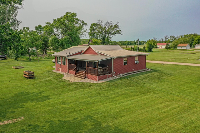 17366 Ryan Dr NE, Osakis, MN 56360 - back of property featuring a lawn, metal roof, and a fire pit