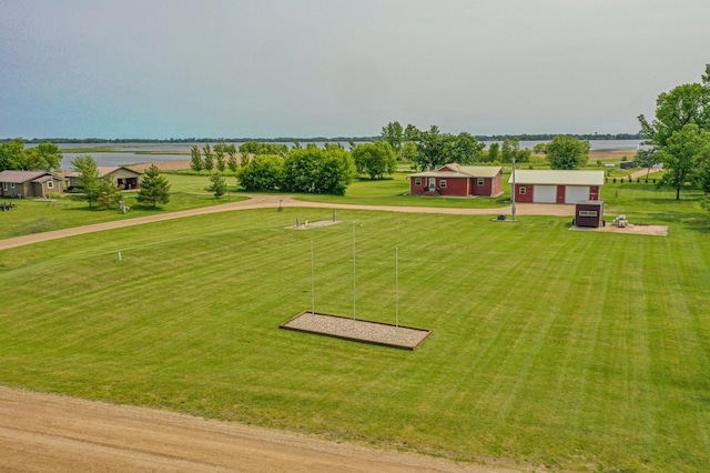 17366 Ryan Dr NE, Osakis, MN 56360 - view of grassy yard with dirt driveway, a garage, and a water view