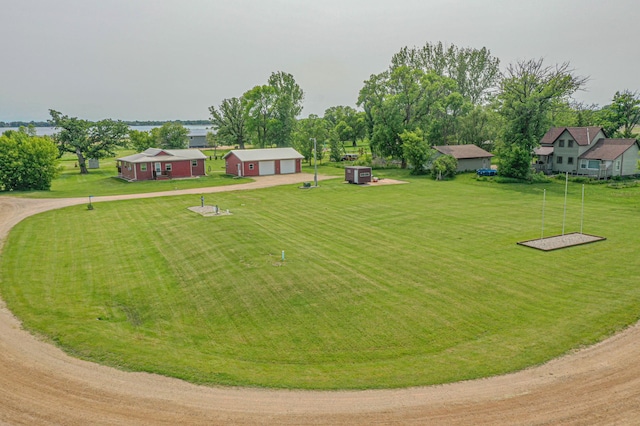 17366 Ryan Dr NE, Osakis, MN 56360 - view of green lawn featuring dirt driveway, an outbuilding, and a garage