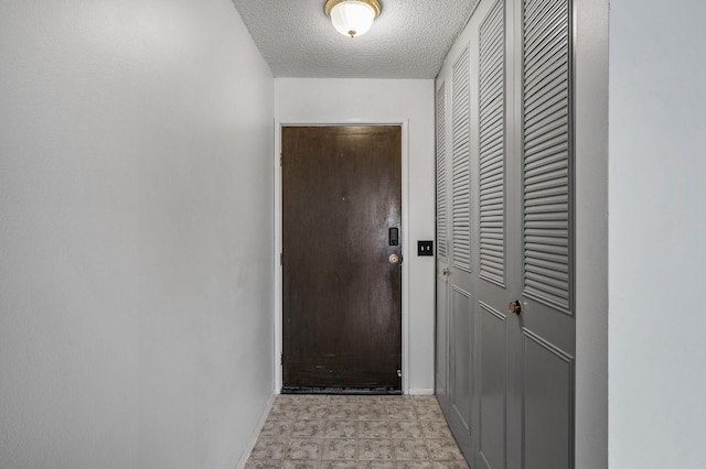 10311 Cedar Lake Rd Unit 202, Minnetonka, MN 55305 - doorway featuring baseboards and a textured ceiling