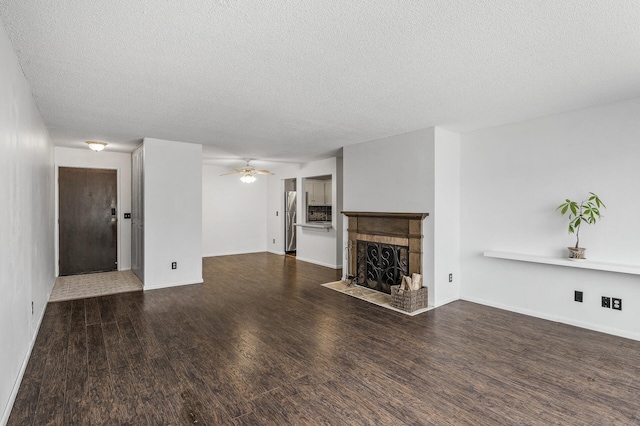 10311 Cedar Lake Rd Unit 202, Minnetonka, MN 55305 - unfurnished living room featuring a fireplace with flush hearth, a textured ceiling, wood finished floors, a ceiling fan, and baseboards