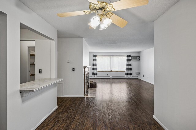 10311 Cedar Lake Rd Unit 202, Minnetonka, MN 55305 - unfurnished living room featuring ceiling fan, a wall mounted air conditioner, wood finished floors, baseboards, and a textured ceiling