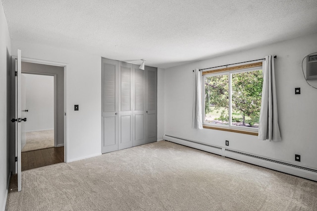 10311 Cedar Lake Rd Unit 202, Minnetonka, MN 55305 - unfurnished bedroom featuring a baseboard heating unit, carpet, a textured ceiling, and a closet