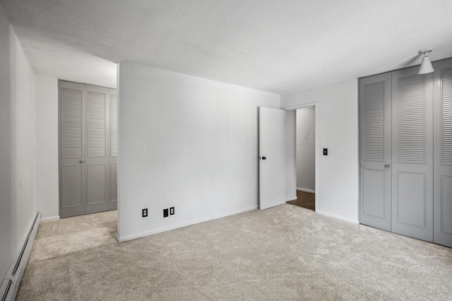 10311 Cedar Lake Rd Unit 202, Minnetonka, MN 55305 - unfurnished bedroom featuring a baseboard radiator, carpet flooring, a textured ceiling, and baseboards