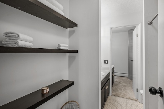 10311 Cedar Lake Rd Unit 202, Minnetonka, MN 55305 - laundry area with light carpet, a baseboard heating unit, and light tile patterned floors