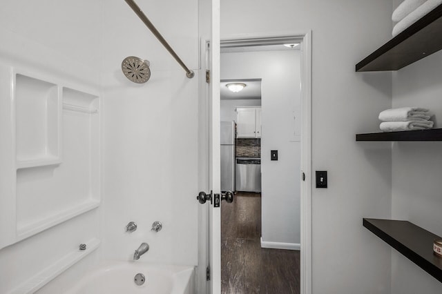 10311 Cedar Lake Rd Unit 202, Minnetonka, MN 55305 - full bathroom featuring washtub / shower combination, wood finished floors, and baseboards