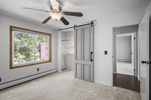 10311 Cedar Lake Rd Unit 202, Minnetonka, MN 55305 - unfurnished bedroom with a baseboard heating unit, a barn door, and carpet