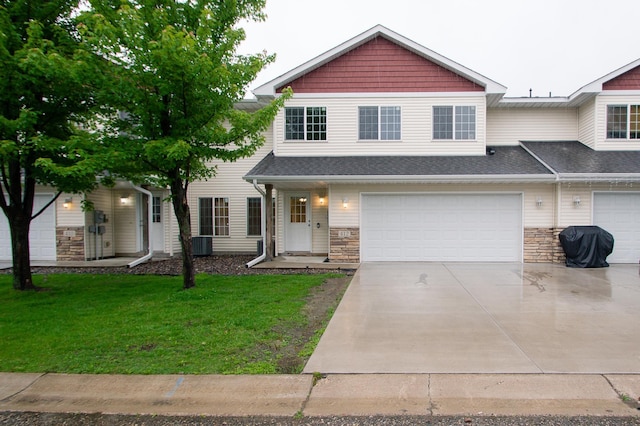 412 Cedar Pl, Maple Lake, MN 55358 - view of front of home featuring concrete driveway, a front yard, stone siding, and a garage