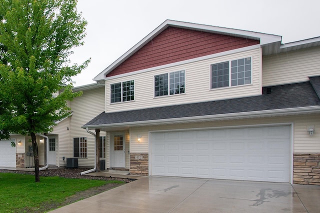 412 Cedar Pl, Maple Lake, MN 55358 - view of front of house featuring driveway, stone siding, a garage, and a shingled roof