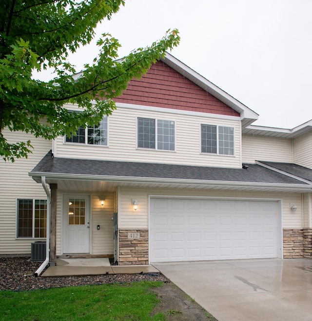 412 Cedar Pl, Maple Lake, MN 55358 - view of front of property featuring driveway, stone siding, and an attached garage