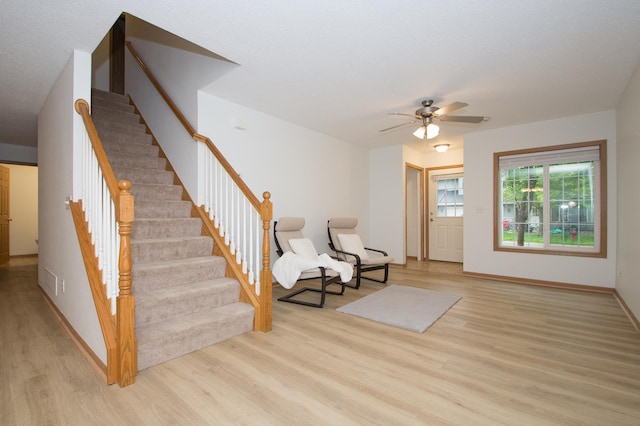 412 Cedar Pl, Maple Lake, MN 55358 - living area featuring light wood finished floors, stairway, and ceiling fan