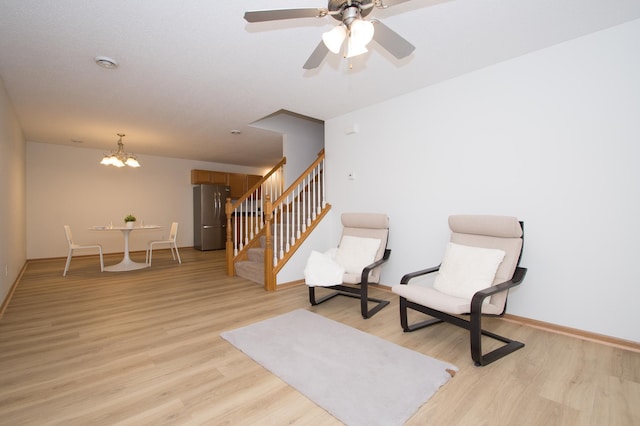 412 Cedar Pl, Maple Lake, MN 55358 - living area with light wood finished floors, stairway, a chandelier, and ceiling fan