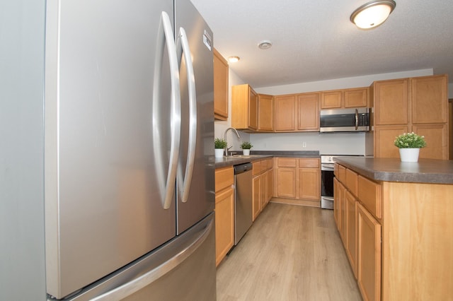 412 Cedar Pl, Maple Lake, MN 55358 - kitchen with appliances with stainless steel finishes, light wood-style flooring, and dark countertops
