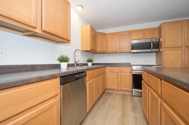 412 Cedar Pl, Maple Lake, MN 55358 - kitchen featuring appliances with stainless steel finishes, light wood-style floors, dark countertops, light brown cabinets, and recessed lighting