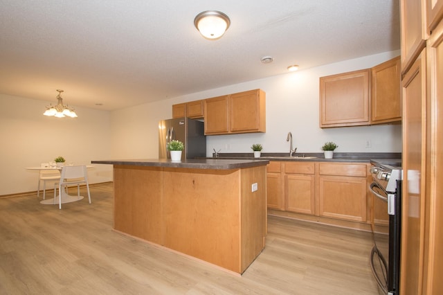 412 Cedar Pl, Maple Lake, MN 55358 - kitchen featuring appliances with stainless steel finishes, dark countertops, light wood-style flooring, a kitchen island, and a chandelier