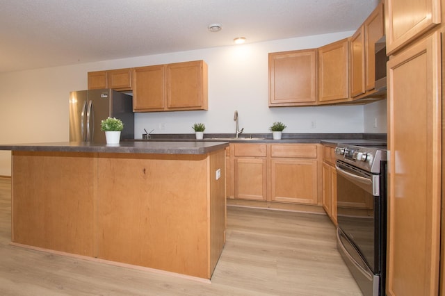 412 Cedar Pl, Maple Lake, MN 55358 - kitchen with stainless steel appliances, light wood-style flooring, dark countertops, and a center island