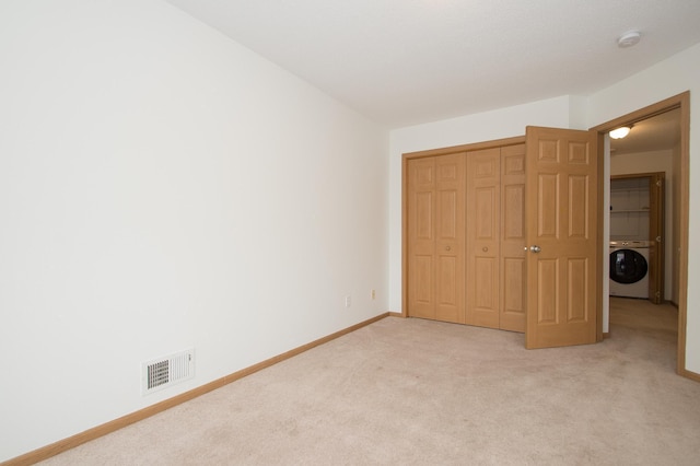 412 Cedar Pl, Maple Lake, MN 55358 - unfurnished bedroom with washer / clothes dryer, light carpet, and a closet