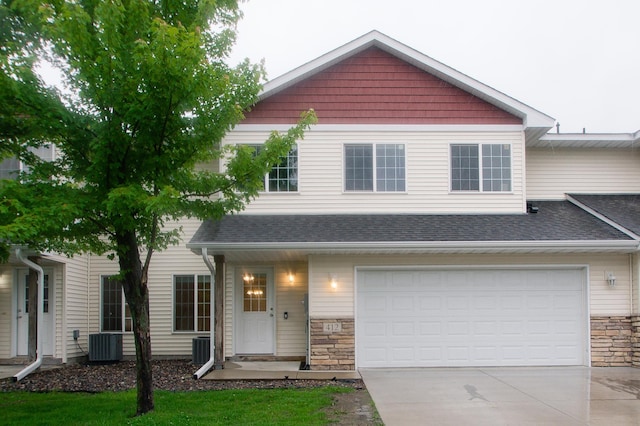 412 Cedar Pl, Maple Lake, MN 55358 - view of front of house featuring concrete driveway, stone siding, a shingled roof, and an attached garage