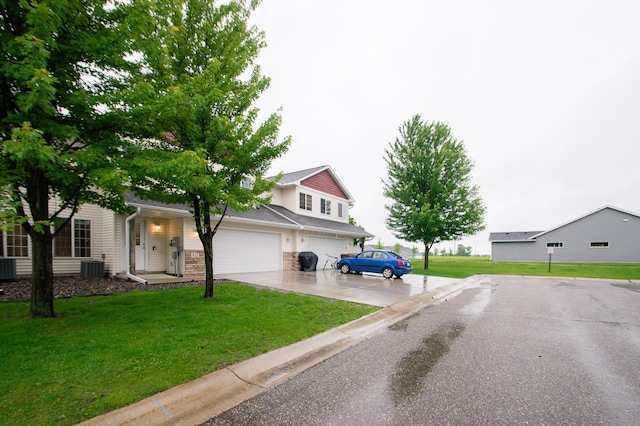 412 Cedar Pl, Maple Lake, MN 55358 - view of front facade featuring concrete driveway, a front lawn, an attached garage, and stone siding