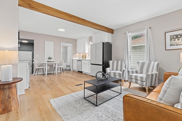 232 26th Ave N, Saint Cloud, MN 56303 - living room with light wood-style floors and beamed ceiling