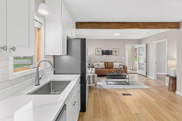 232 26th Ave N, Saint Cloud, MN 56303 - kitchen featuring white cabinetry, beam ceiling, light wood-type flooring, healthy amount of natural light, and recessed lighting