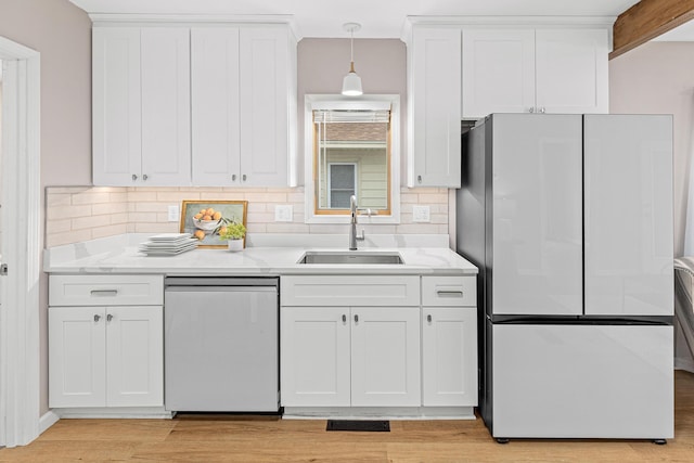 232 26th Ave N, Saint Cloud, MN 56303 - kitchen with freestanding refrigerator, dishwashing machine, decorative backsplash, and white cabinets