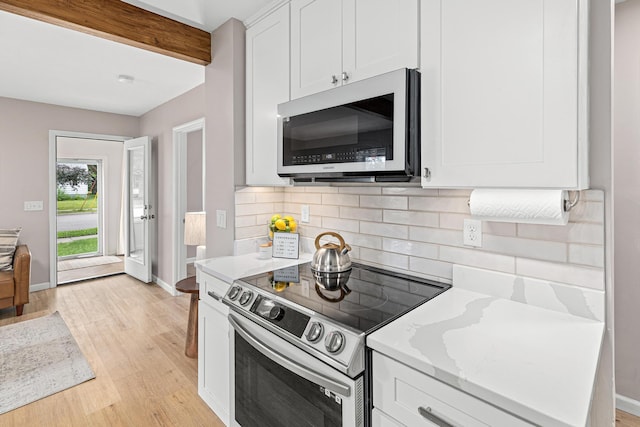 232 26th Ave N, Saint Cloud, MN 56303 - kitchen with appliances with stainless steel finishes, decorative backsplash, light wood finished floors, white cabinets, and beamed ceiling