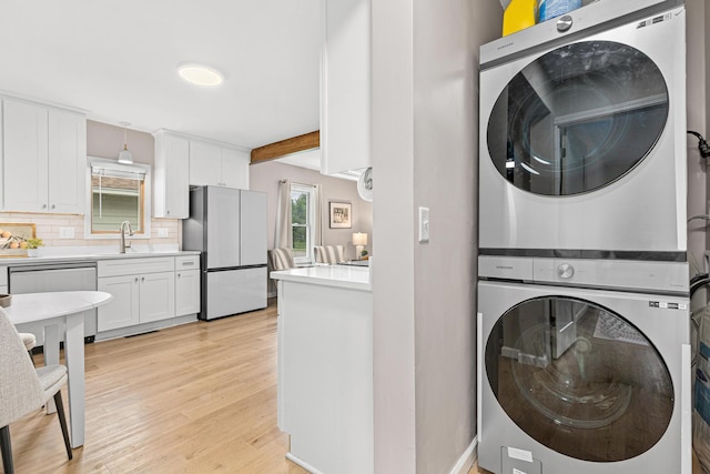 232 26th Ave N, Saint Cloud, MN 56303 - laundry room with stacked washer and clothes dryer and light wood finished floors