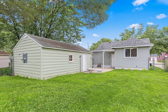 232 26th Ave N, Saint Cloud, MN 56303 - rear view of house featuring an outbuilding, a patio, and a shingled roof