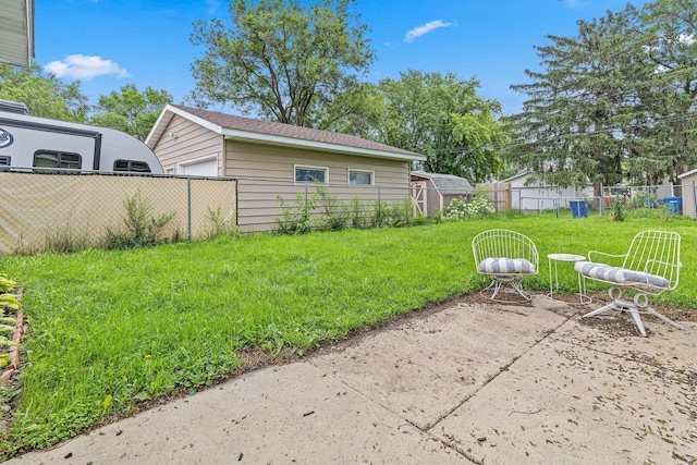 232 26th Ave N, Saint Cloud, MN 56303 - fenced backyard with an outbuilding, a detached garage, and a patio