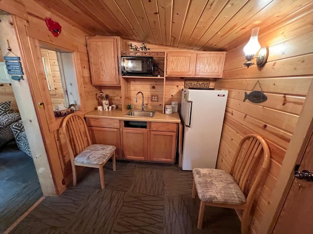 32074 315th Pl, Glen Twp, MN 56431 - kitchen with freestanding refrigerator, a sink, black microwave, wooden walls, and wood ceiling