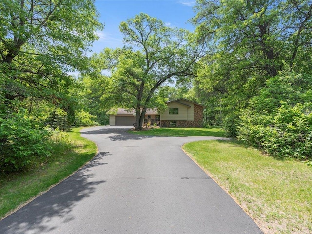 5863 Foley Rd, Baxter, MN 56425 - view of front of house with driveway, a front lawn, and brick siding