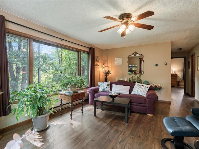 5863 Foley Rd, Baxter, MN 56425 - living area featuring a ceiling fan, wood finished floors, a textured ceiling, and a baseboard heating unit