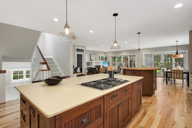 1241 Cedar Lake Rd S, Minneapolis, MN 55416 - kitchen with stainless steel gas cooktop, a center island, french doors, light wood-type flooring, and open floor plan