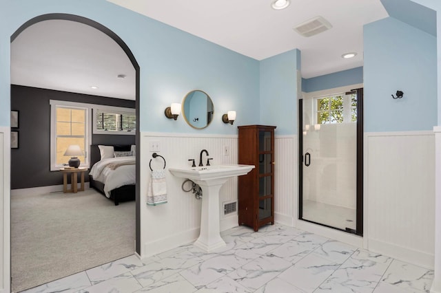 1241 Cedar Lake Rd S, Minneapolis, MN 55416 - bathroom featuring a wainscoted wall, marble look tile flooring, a stall shower, ensuite bathroom, and recessed lighting