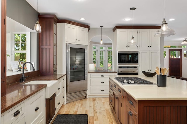 1241 Cedar Lake Rd S, Minneapolis, MN 55416 - kitchen featuring appliances with stainless steel finishes, a sink, plenty of natural light, light wood-style flooring, and recessed lighting