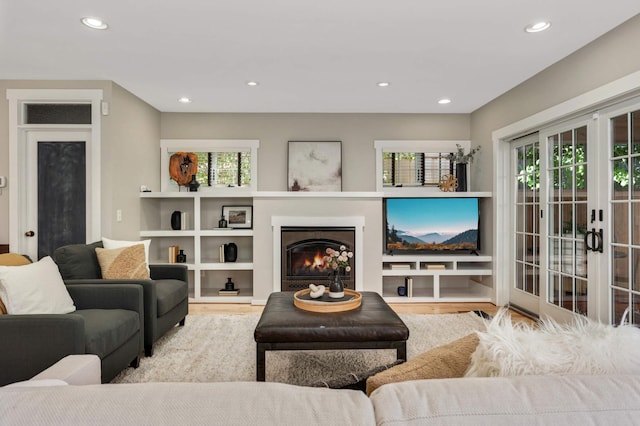 1241 Cedar Lake Rd S, Minneapolis, MN 55416 - living area featuring wood finished floors, plenty of natural light, recessed lighting, and a lit fireplace