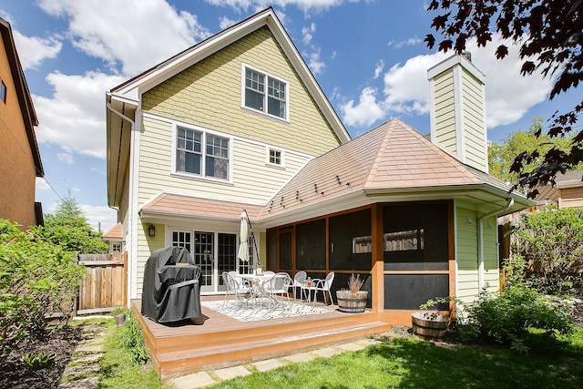 1241 Cedar Lake Rd S, Minneapolis, MN 55416 - back of house featuring a sunroom, a deck, and a chimney