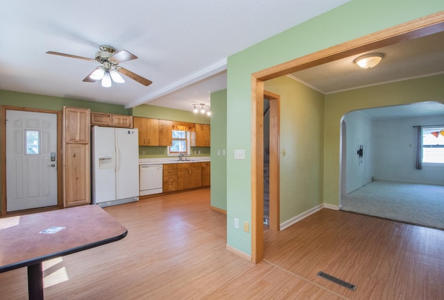 1618 10th St N, Fargo, ND 58102 - kitchen featuring white appliances, arched walkways, a sink, and light wood-style floors