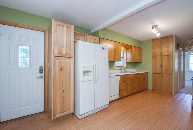1618 10th St N, Fargo, ND 58102 - kitchen featuring white appliances, light countertops, light wood-style flooring, a sink, and beamed ceiling