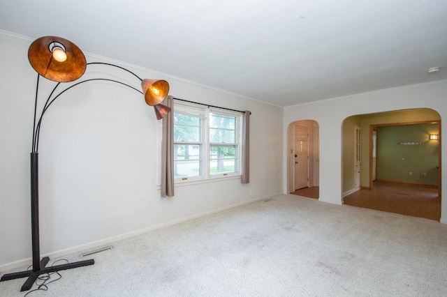 1618 10th St N, Fargo, ND 58102 - carpeted empty room featuring arched walkways, ornamental molding, and baseboards