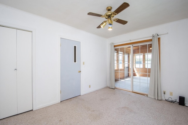 1618 10th St N, Fargo, ND 58102 - unfurnished bedroom featuring access to outside, carpet flooring, ornamental molding, baseboards, and a ceiling fan