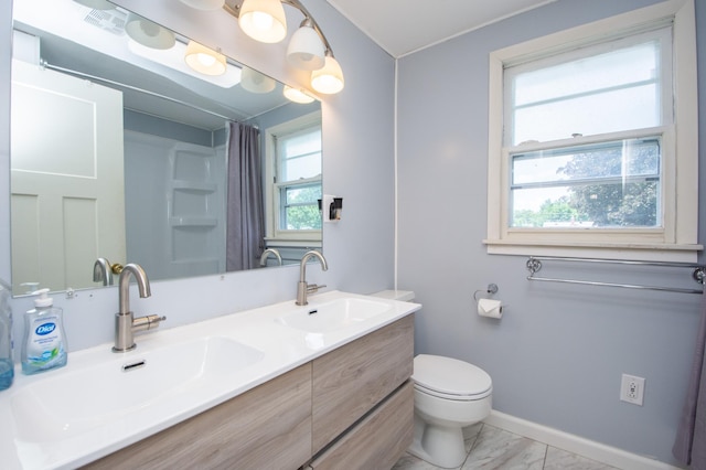 1618 10th St N, Fargo, ND 58102 - bathroom with marble finish floors, plenty of natural light, double vanity, and a shower with curtain