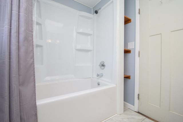1618 10th St N, Fargo, ND 58102 - bathroom featuring shower / bath combo with shower curtain, marble look tile flooring, and baseboards
