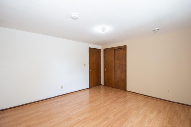 1618 10th St N, Fargo, ND 58102 - unfurnished bedroom with light wood-style floors, baseboards, and two closets