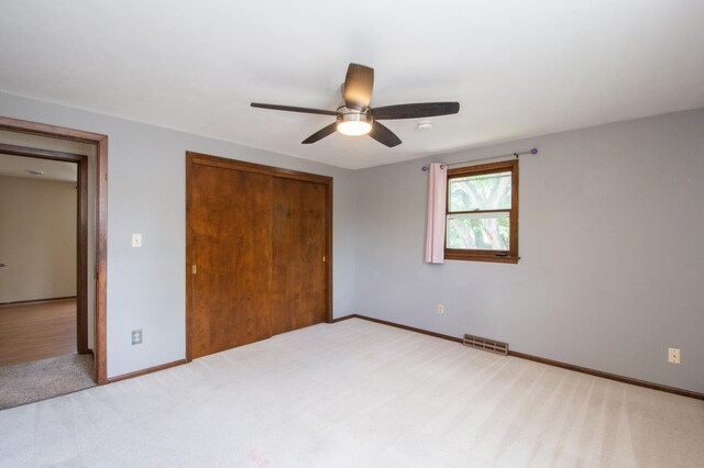 1618 10th St N, Fargo, ND 58102 - unfurnished bedroom featuring a closet, carpet floors, baseboards, and a ceiling fan
