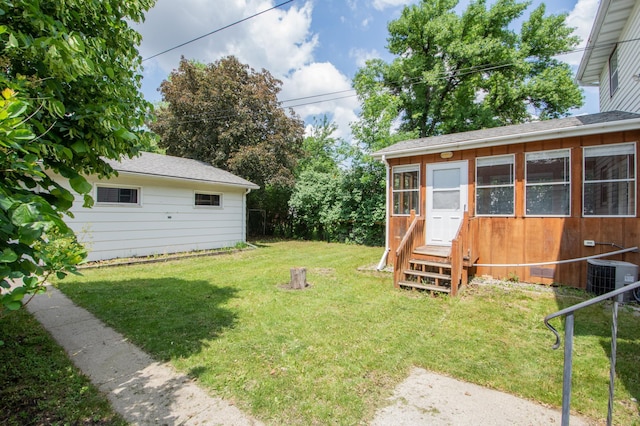 1618 10th St N, Fargo, ND 58102 - view of green lawn featuring entry steps and central AC